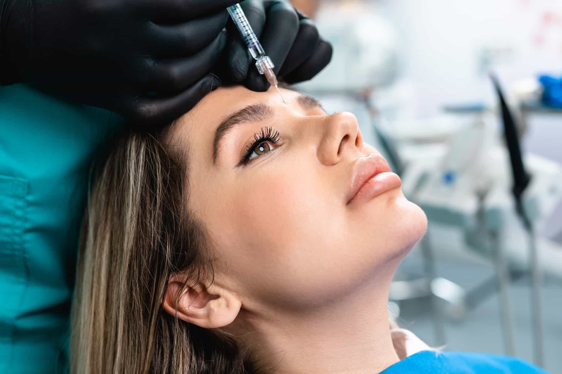 A Young lady getting Injection on her forehead | Botox & Dysport | AgeLess Medical Aesthetics in Cheyenne, WY