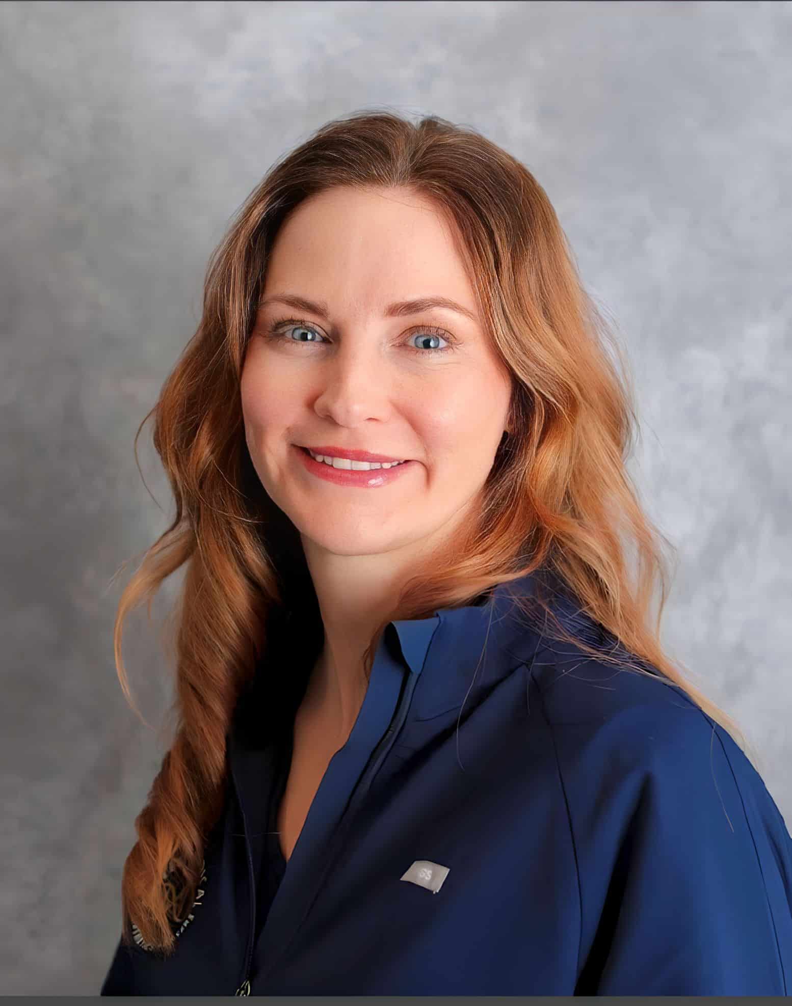 a woman with long hair wearing a blue shirt