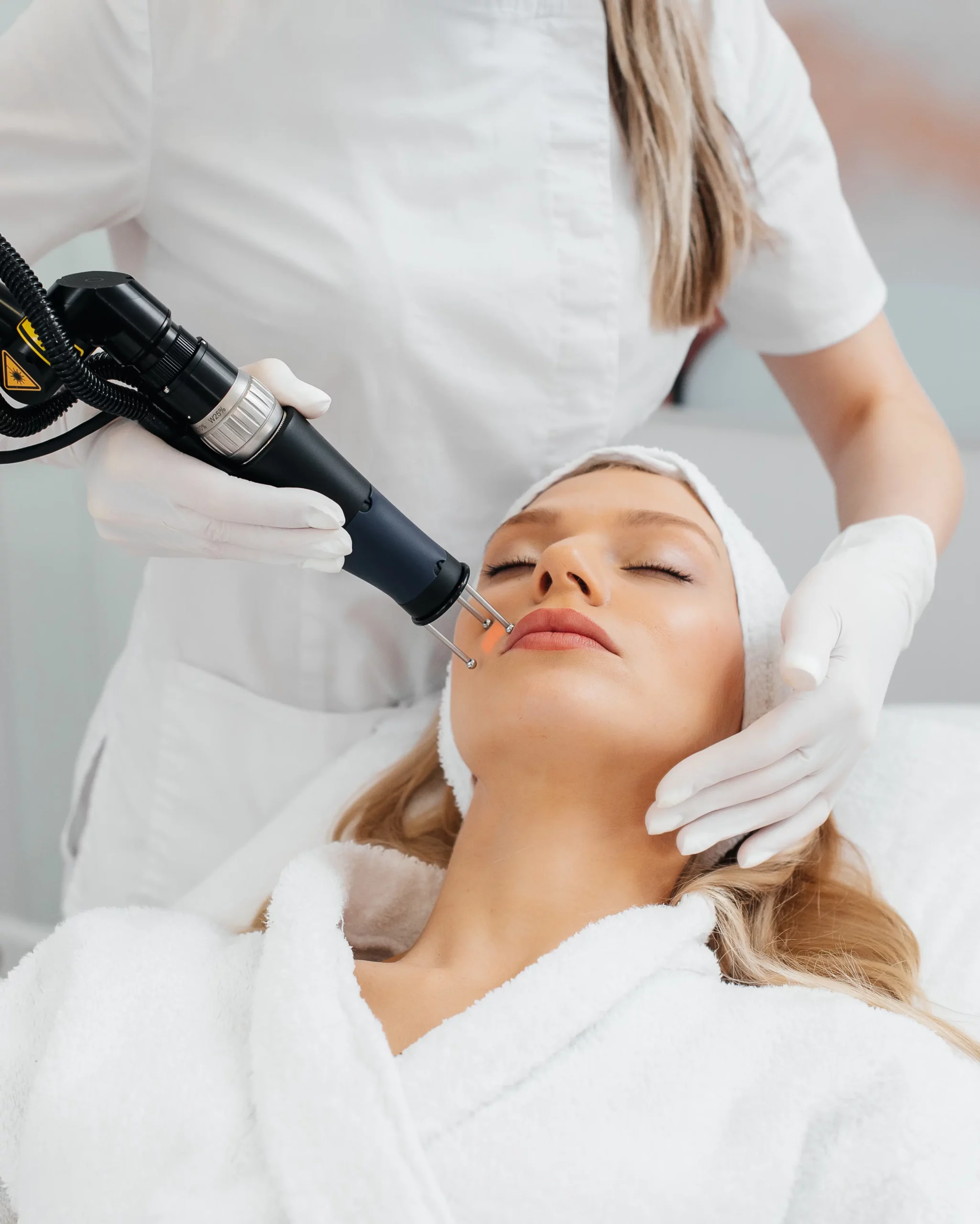 Young woman undergoing laser skin resurfacing treatment at a clinic in Cheyenne, WY