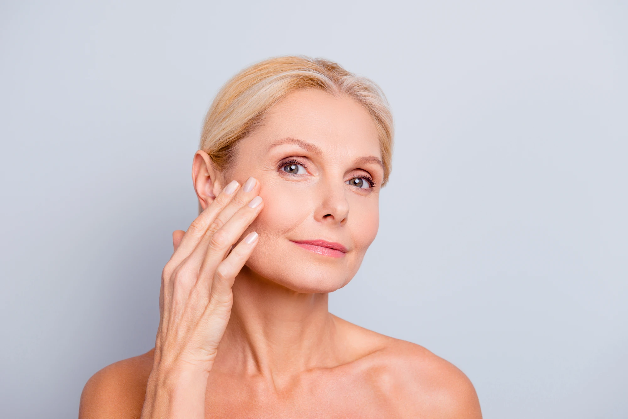 A close-up of a woman caring for her facial